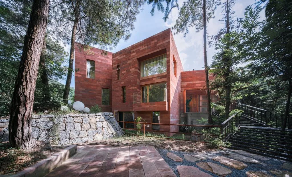 BIM Architecture | Red Stone Houses in High Mountains, Flowing Waters, and Pine Forests/Plain Architecture Design Firm