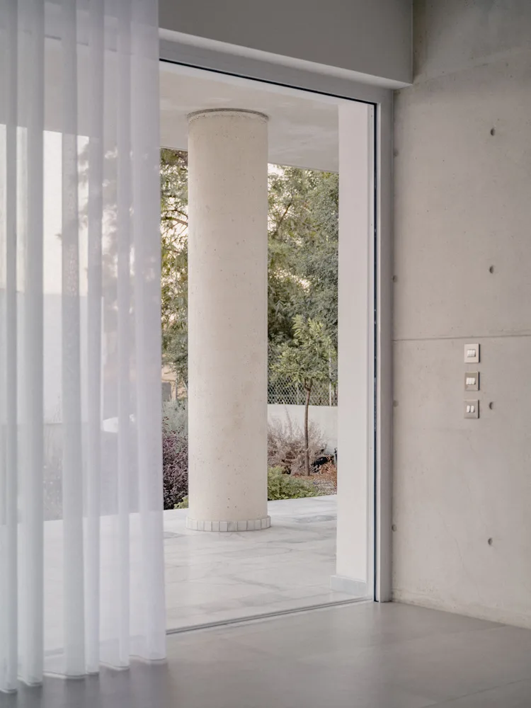 Sculpture like exposed concrete runs through the entire narrow rectangular flat design