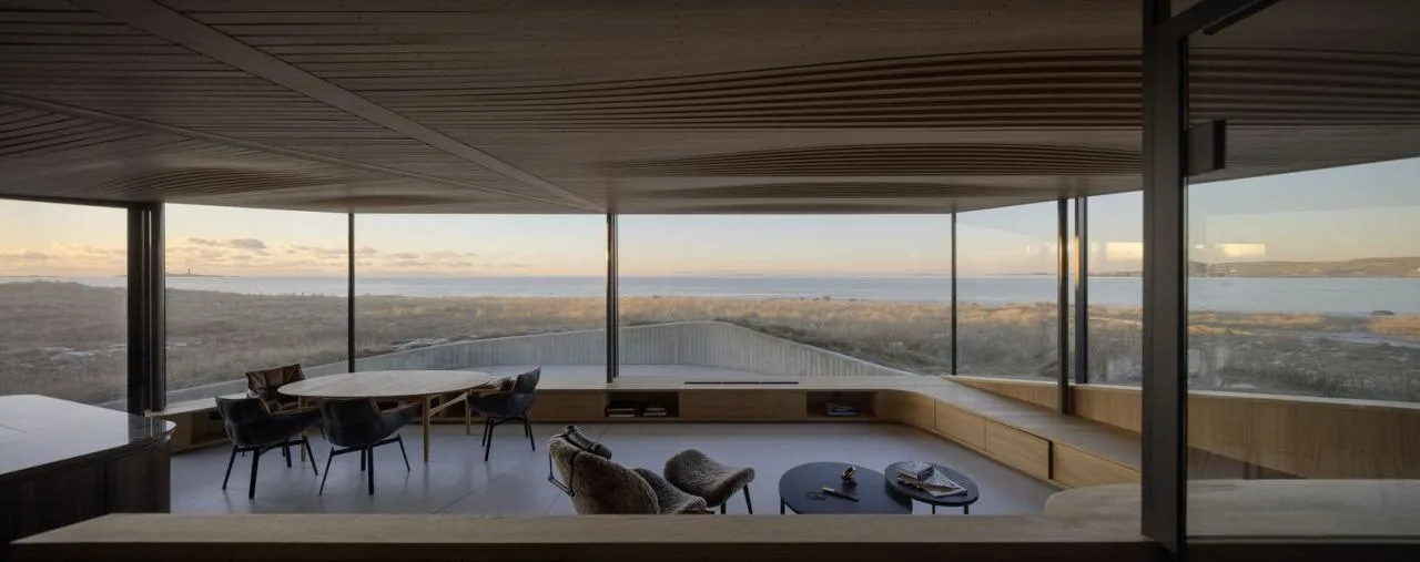 A vacation home design that coexists with sand dunes and the sea, showcasing the natural poetic and expansive beauty of the Norwegian coast