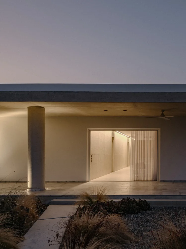 Sculpture like exposed concrete runs through the entire narrow rectangular flat design