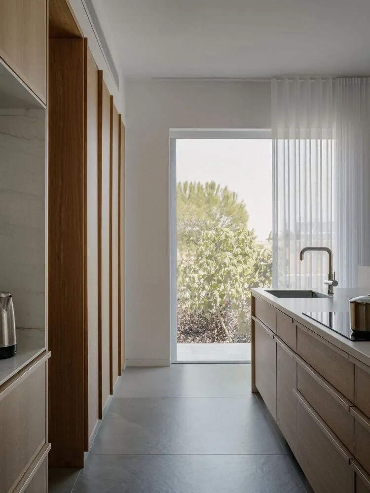 Sculpture like exposed concrete runs through the entire narrow rectangular flat design