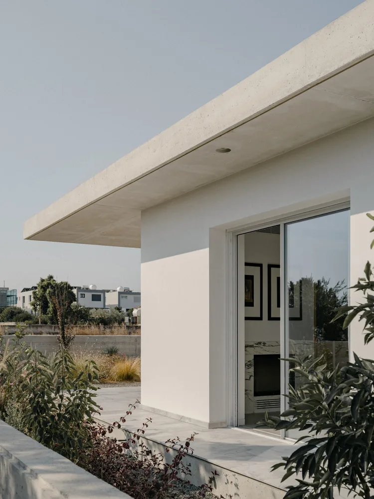 Sculpture like exposed concrete runs through the entire narrow rectangular flat design
