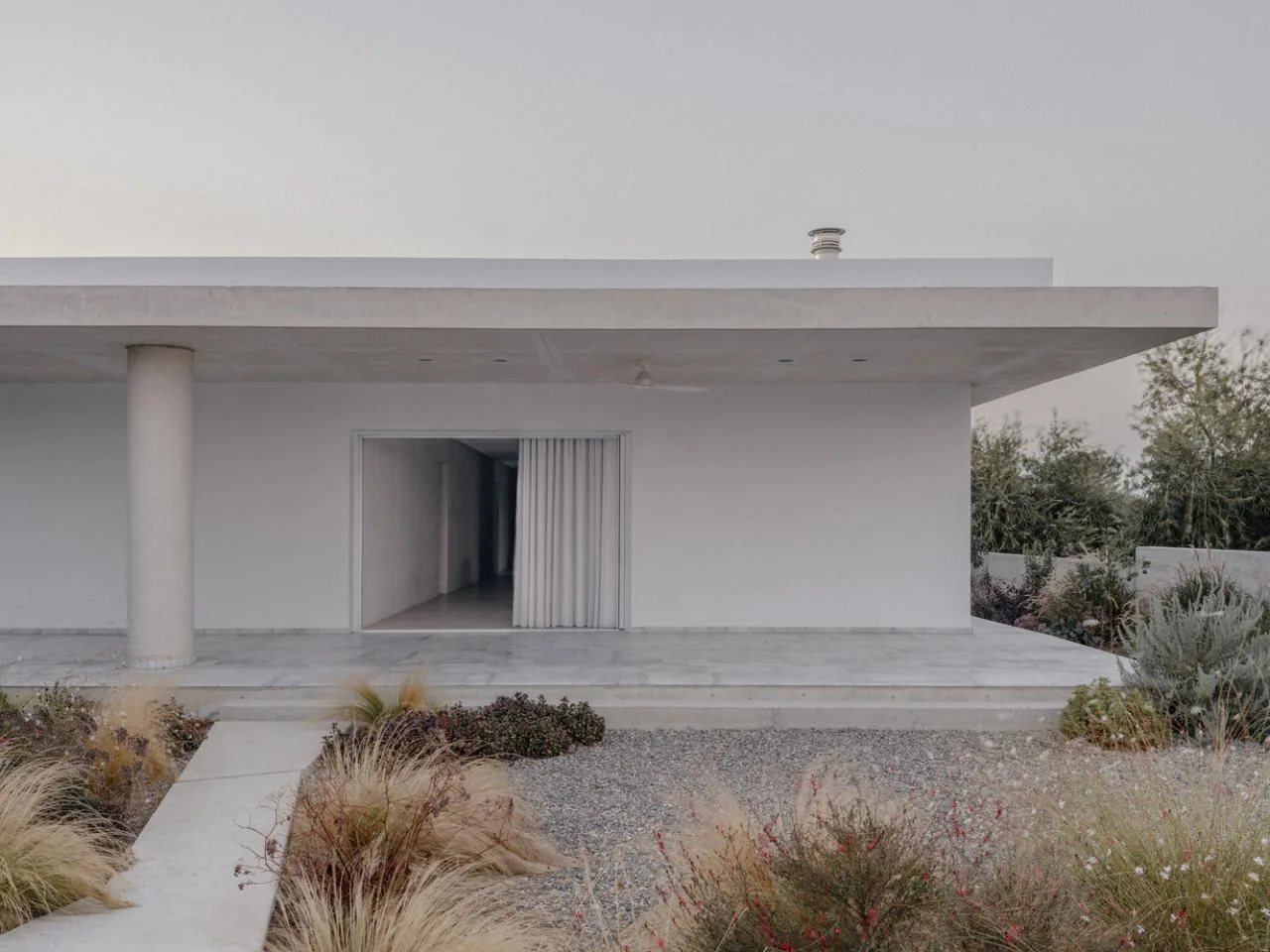Sculpture like exposed concrete runs through the entire narrow rectangular flat design