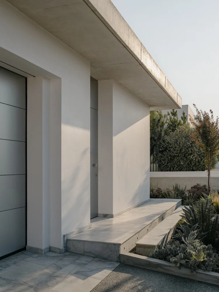 Sculpture like exposed concrete runs through the entire narrow rectangular flat design