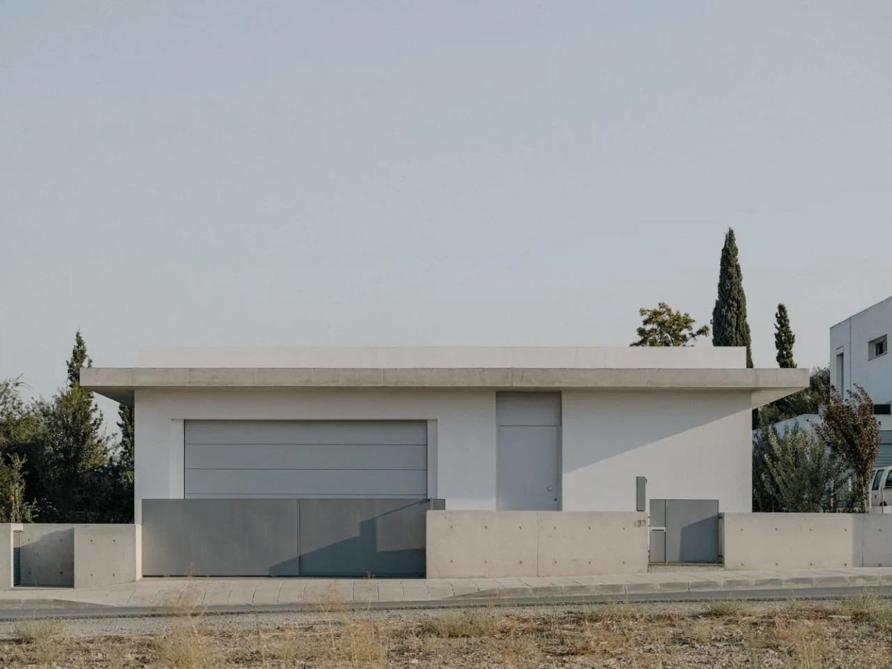 Sculpture like exposed concrete runs through the entire narrow rectangular flat design